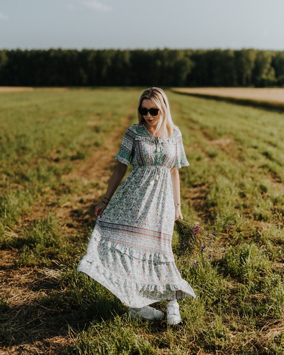 Gorgeous lady in rustic floral dress in countryside