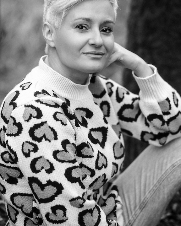 Close-up portrait of blonde lady in sweater monochrome photo
