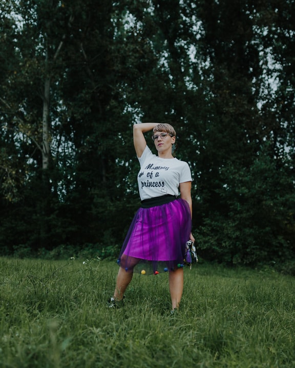 Pretty woman posing in shirt and purple skirt