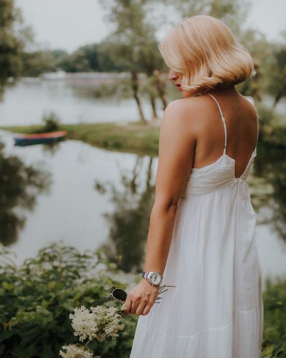 Classic fancy white dress on blonde photo model