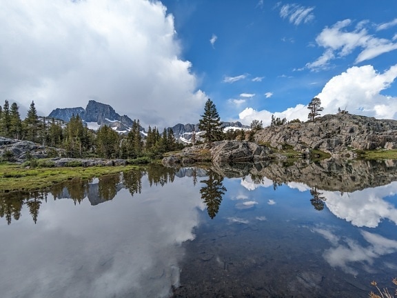 Majestic panorama of lakeside with cloudy blue sky reflection