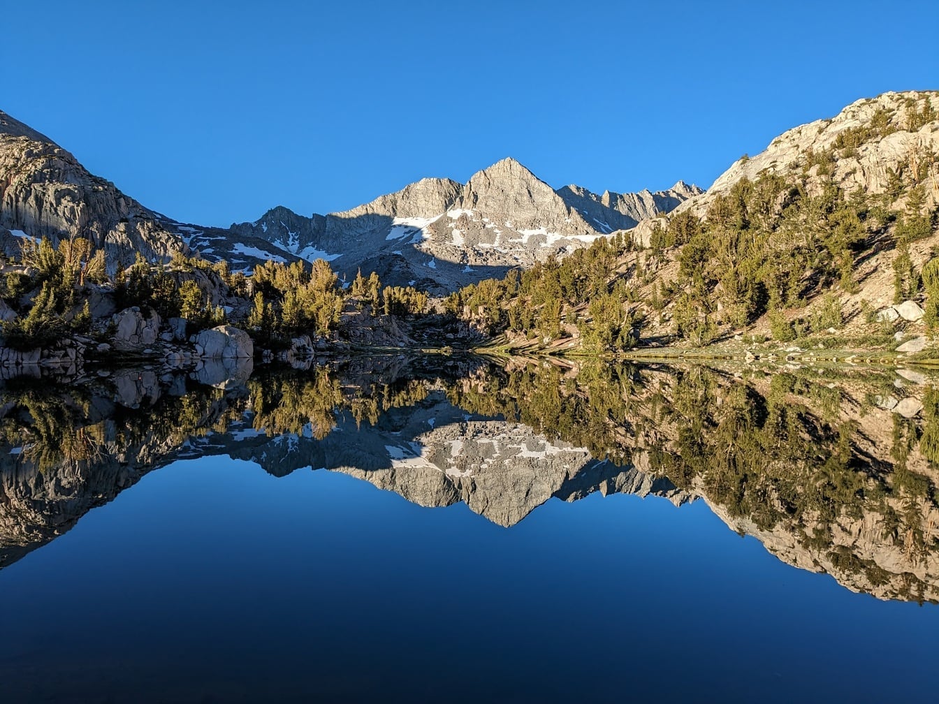 Majestic lakeside panorama with reflection on water