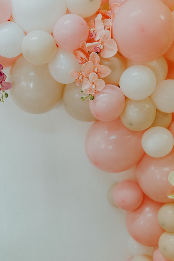 Yellowish and pinkish balloon elegant decoration with orchid flowers