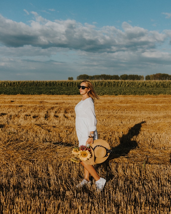Rozkošná mladá žena na pšeničnom poli v letnej sezóne