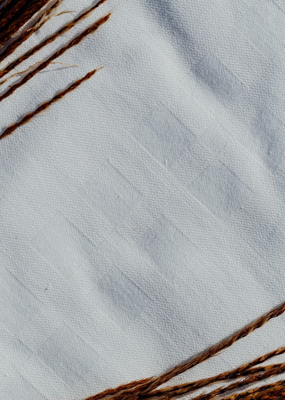 Rectangle patterns on white cotton cloth close-up txture
