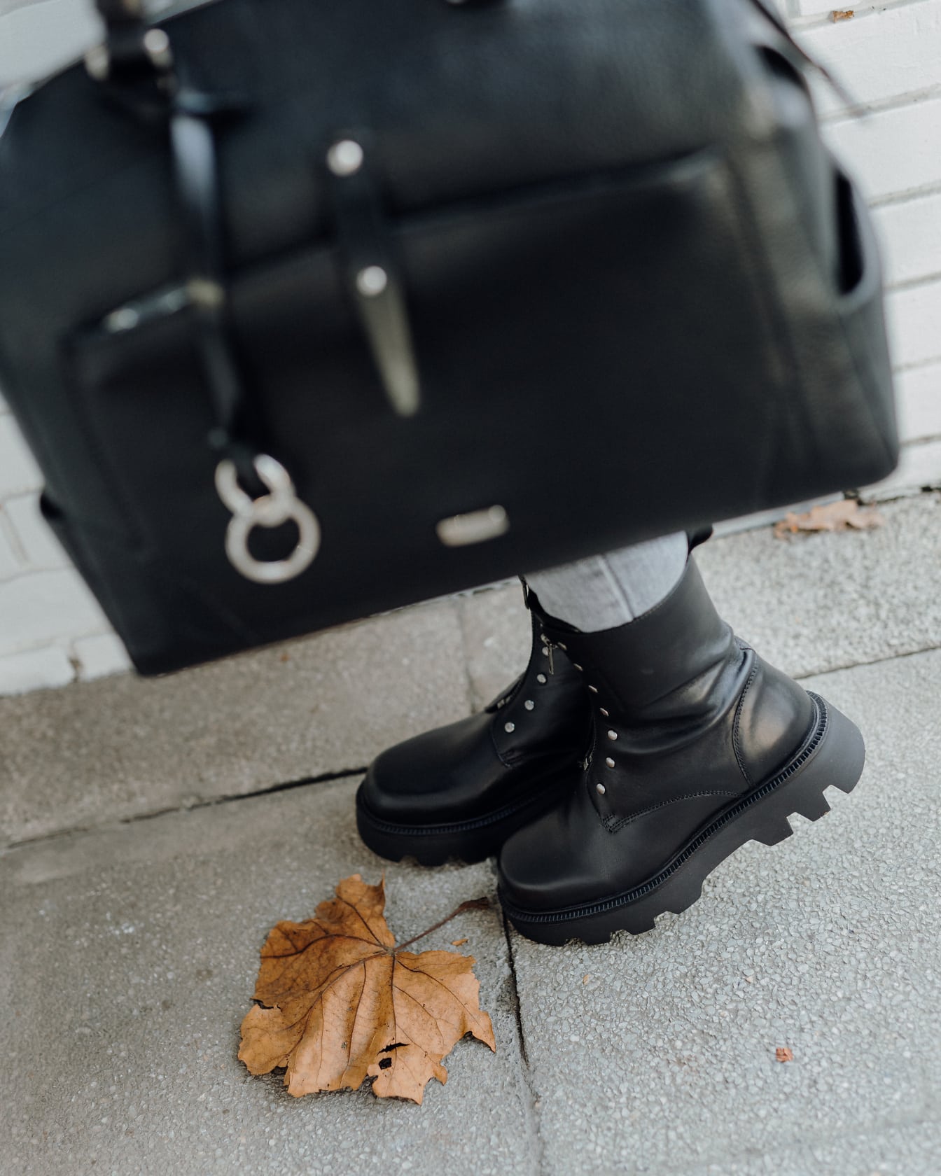 黑色皮革手提包和靴子休闲装