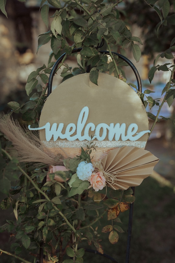 White welcome sign on metal chair arrangement decoration