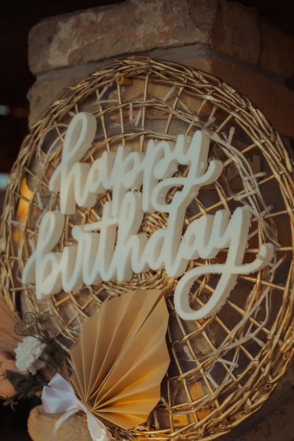 Sign happy birthday on rustic wicker basket arrangement