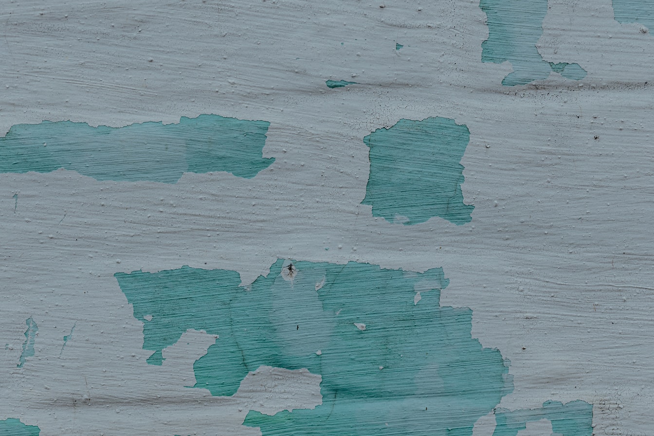 Zielonkawa i biała farba na teksturze zbliżenia ściany