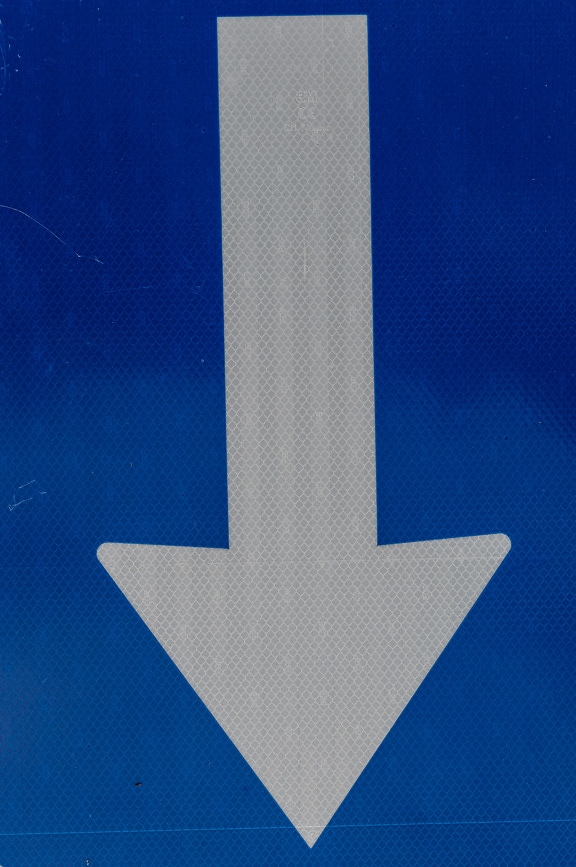 White arrow down sign fluorescent reflective surface
