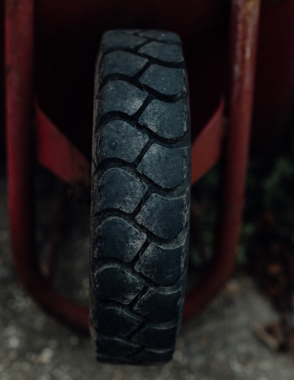 Black rubber tire of pushcart close-up photo