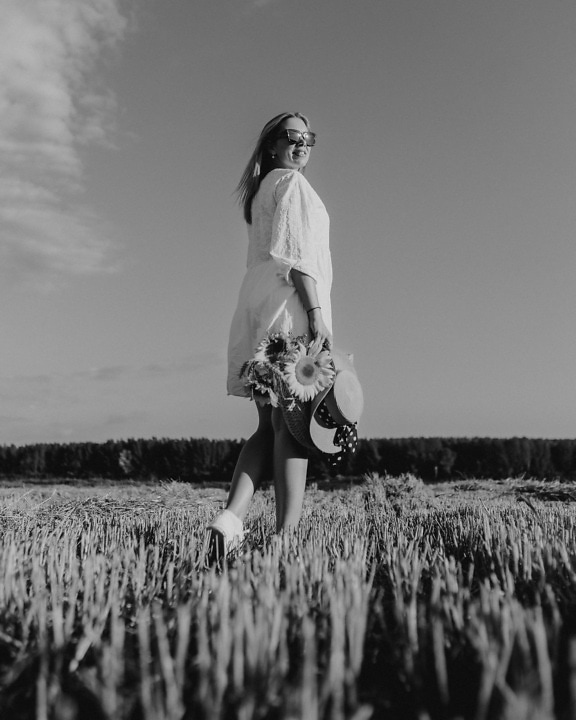 Monochrome portrait of cowgirl in wheat field