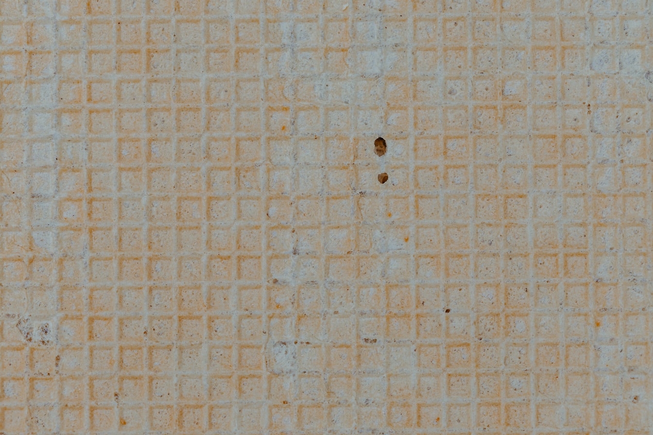 Geelachtig bruine tegel met rechthoek geometrische patroon close-up textuur