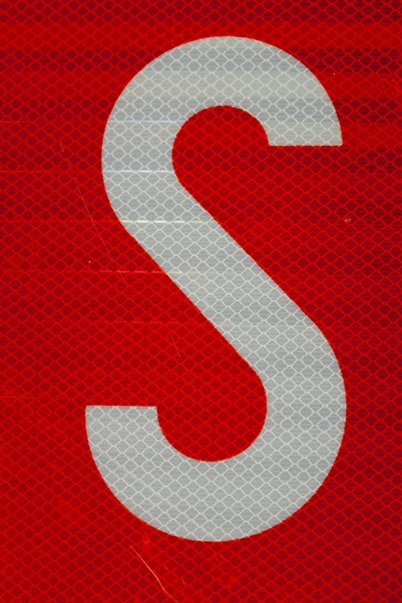 White S symbol on dark red fluorescent background