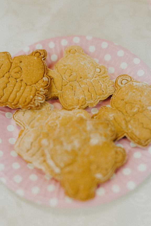 Yellowish brown gingerbread cookies with sugar powder