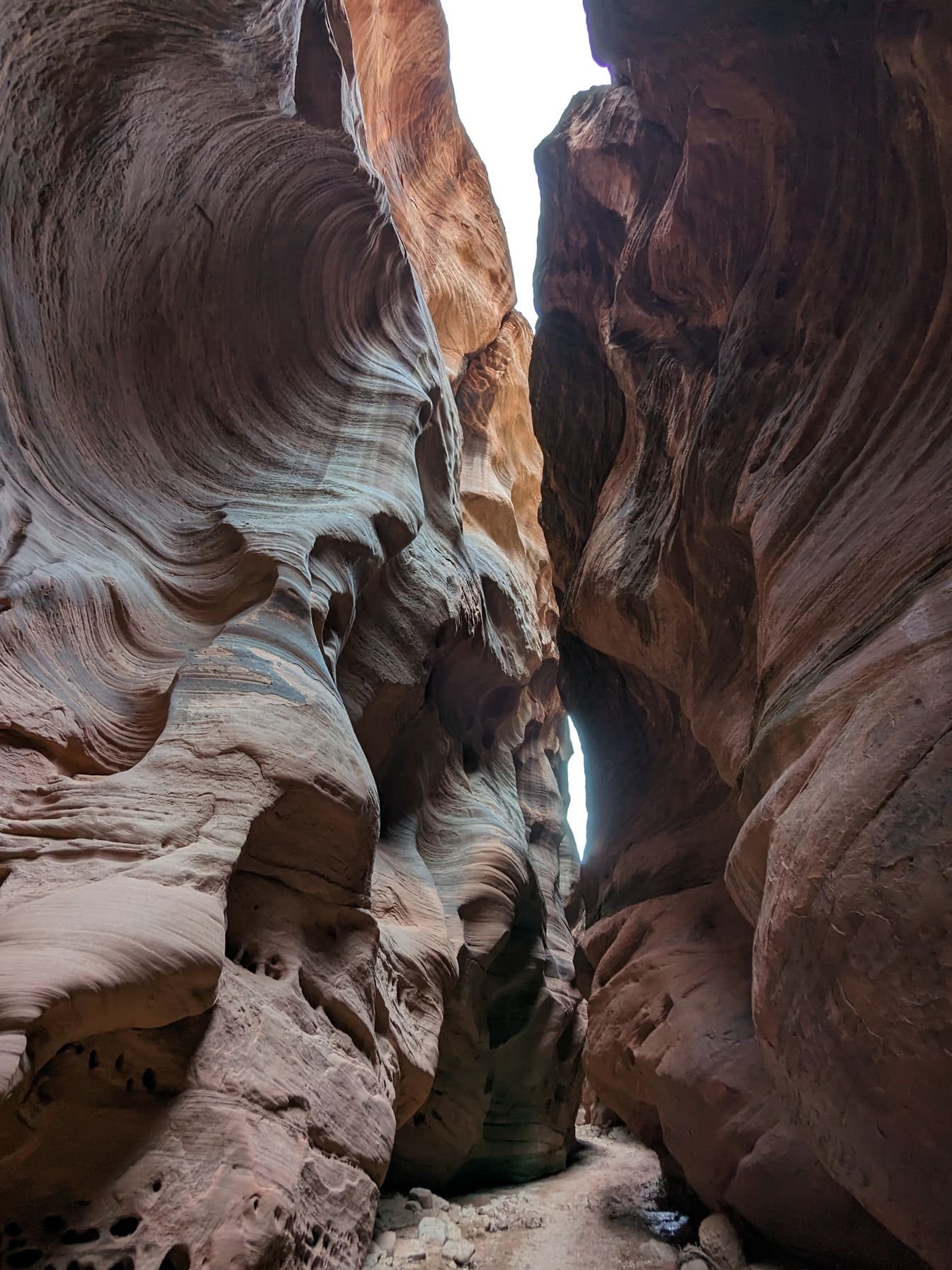Narrow passage by sandstone erosion in desert valley