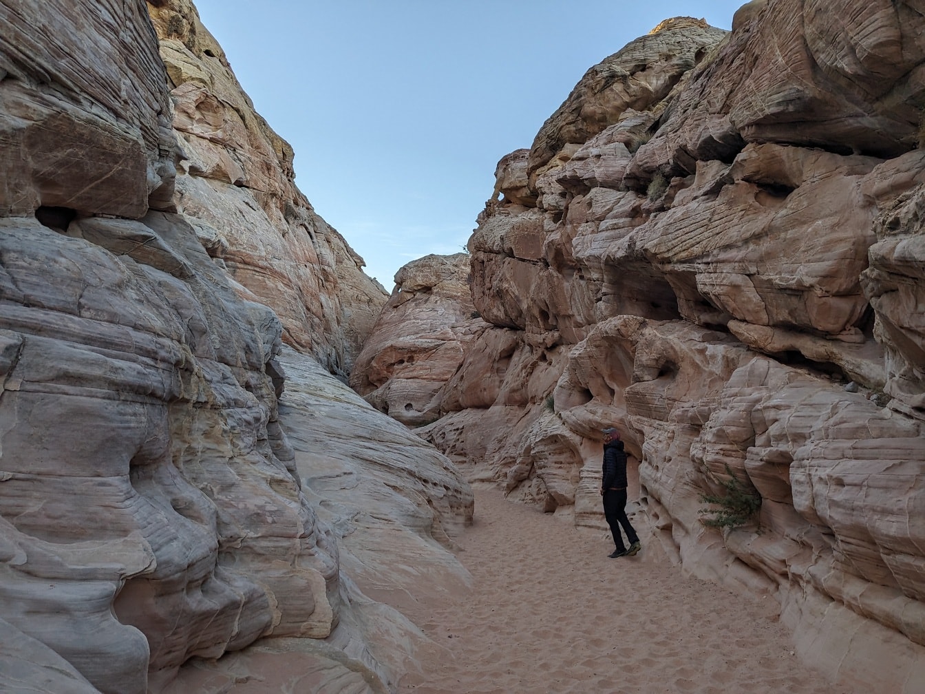 Person standing in narrow canyon in natural park