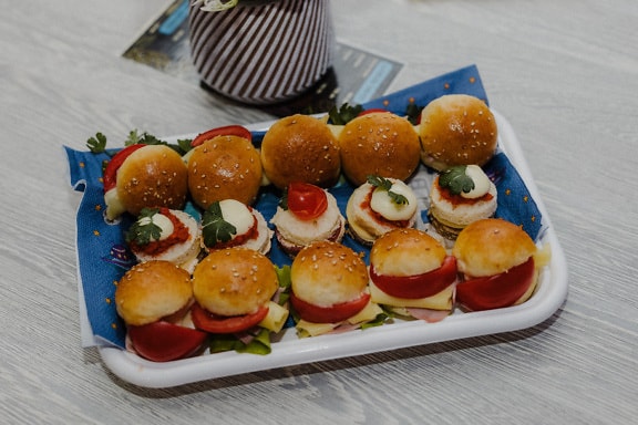 Delicious miniature sandwiches on plate close-up photograph