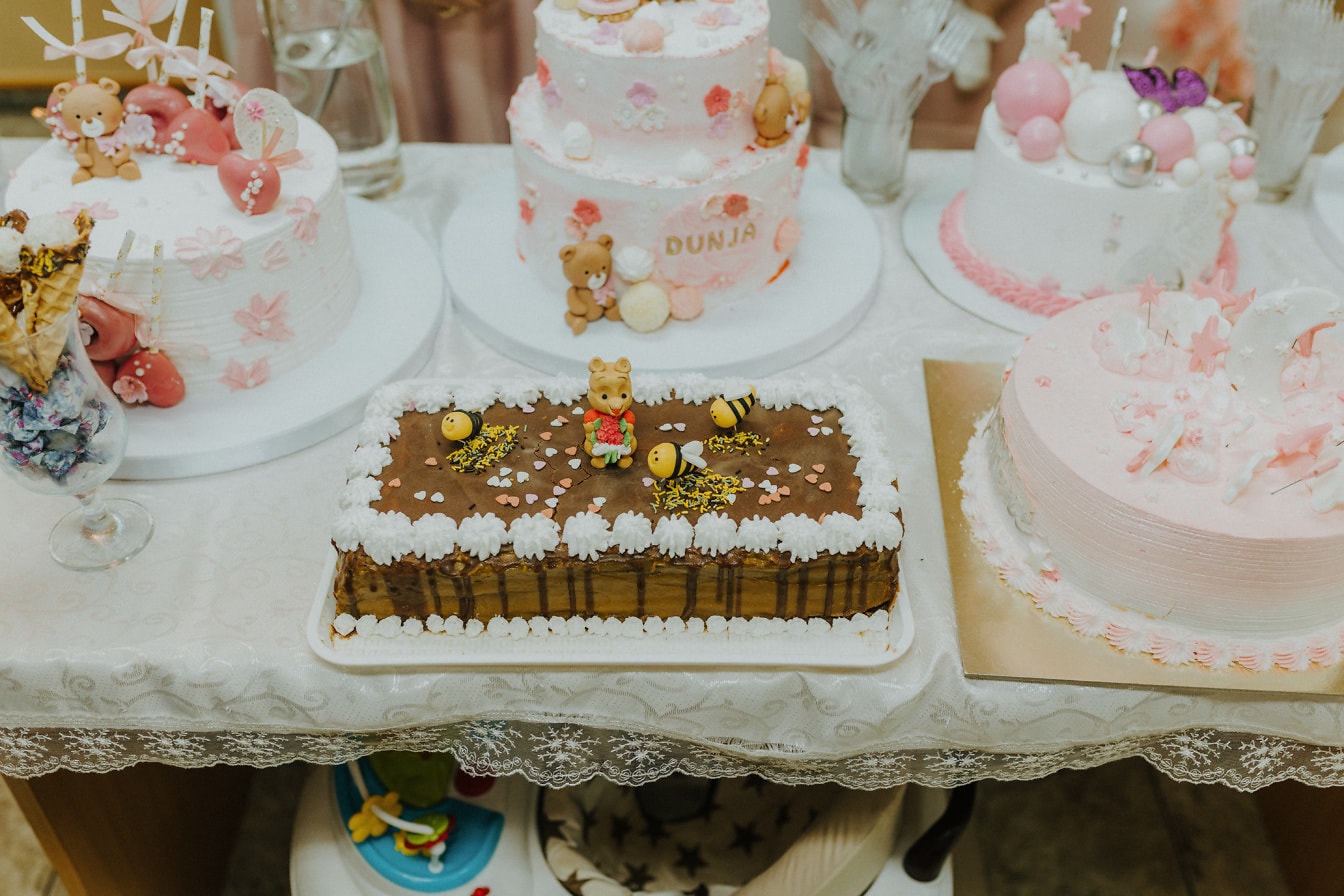 Много праздничных тортов на столе на вечеринке по случаю дня рождения