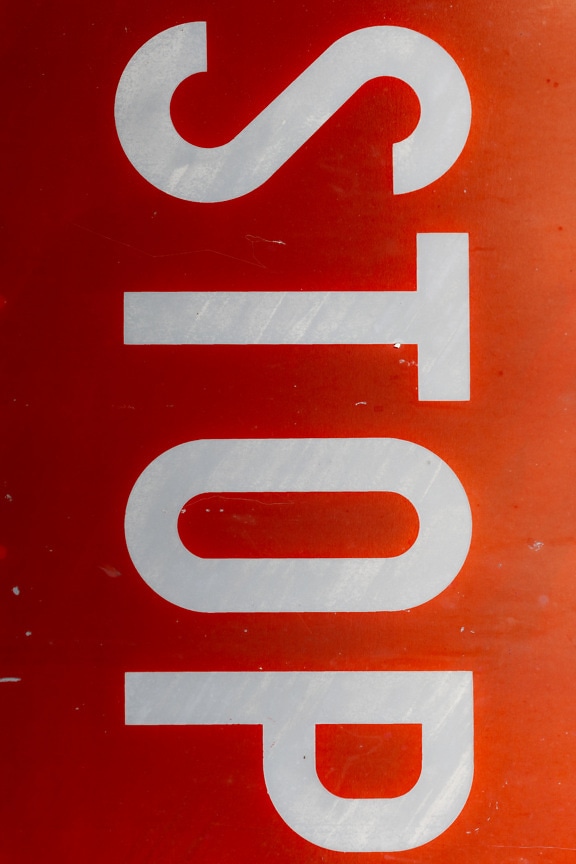 Stop traffic sign with dark red background vertical orientation