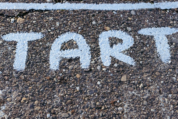 White paint letters on concrete pavement close-up photo