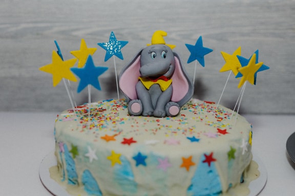 Handmade birthday cake with decoration of elephant toy