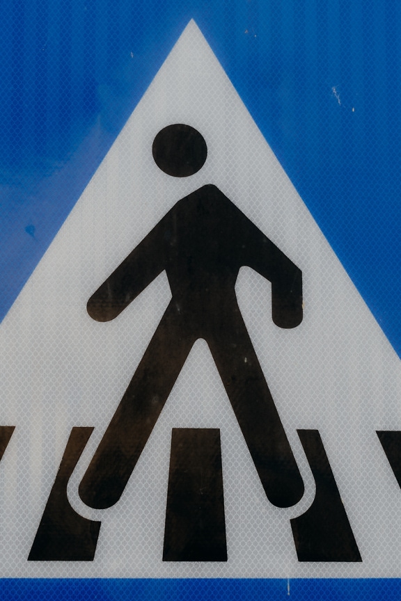 Pedestrian crossing sign with blue background