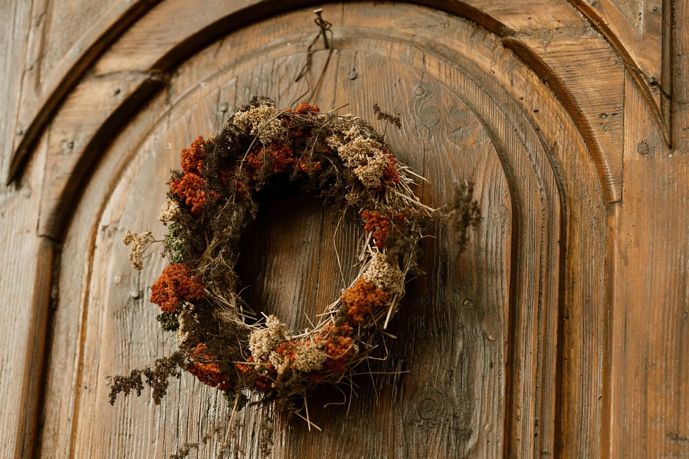 Wreath hanging on a handmade carved front door