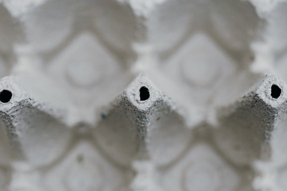 An egg carton texture with shallow depth of field