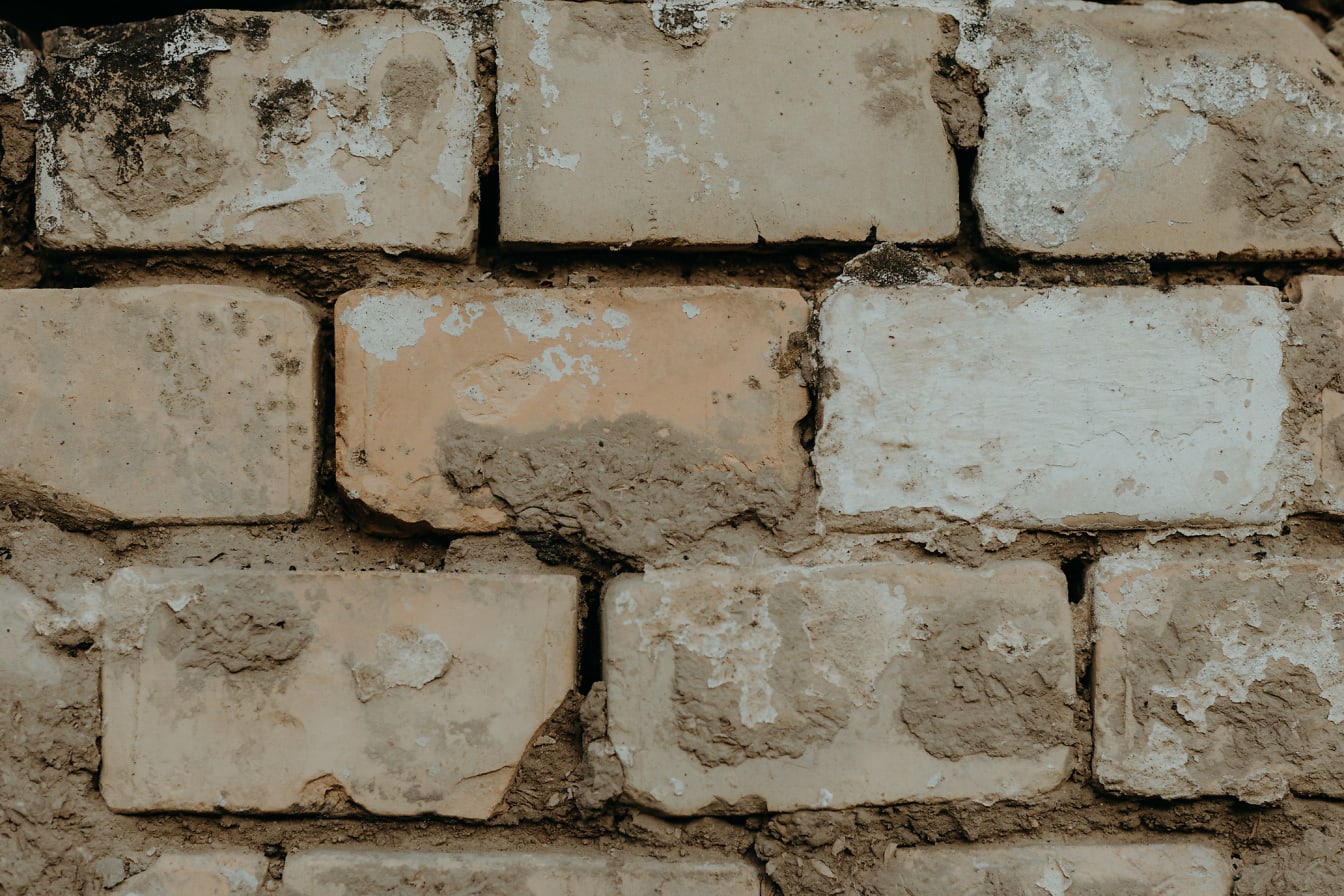 Pozioma ściana murowana z cegły z suchą glebą jako zaprawą z bliska
