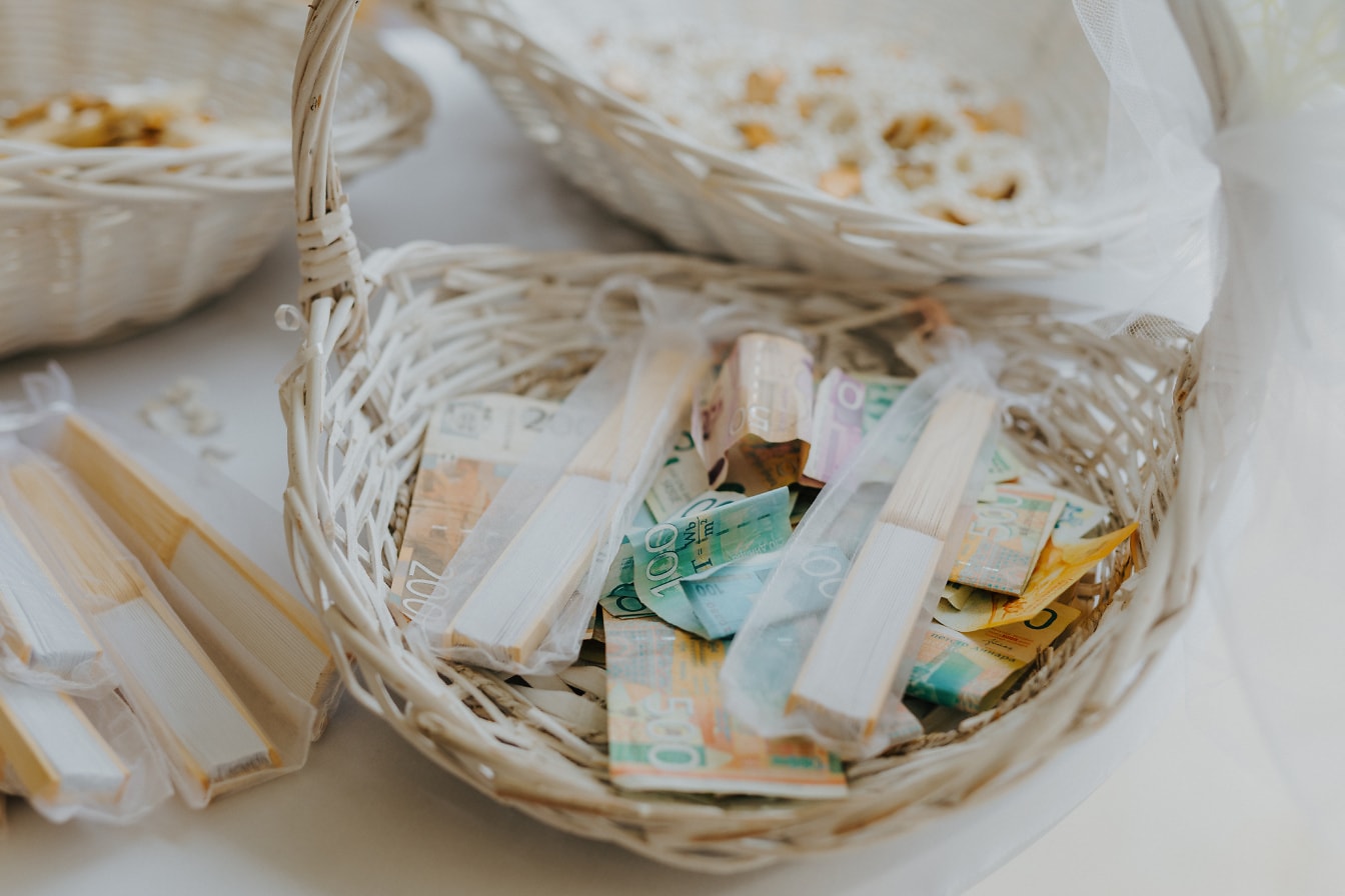 White wicker basket with money in it on wedding ceremony