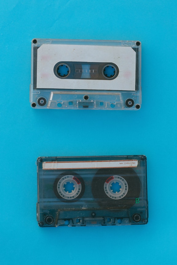 Old audio cassette tape on a blue background