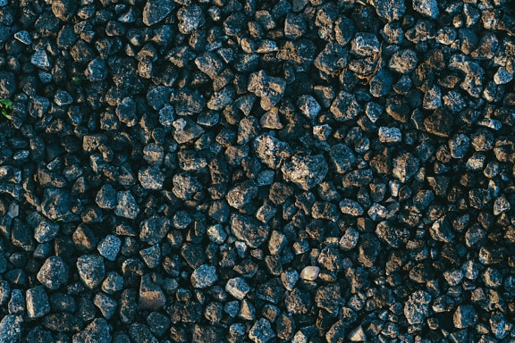 Textura de pequenas rochas de granito preto e acinzentado