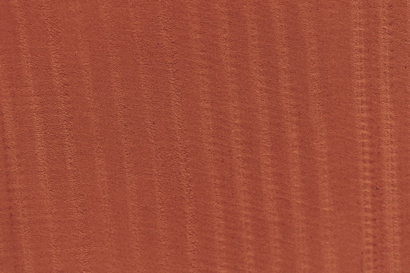 수직선이 있는 빨간색 시멘트 표면의 질감