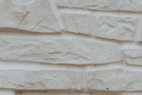Rough texture of beige artificial stone wall