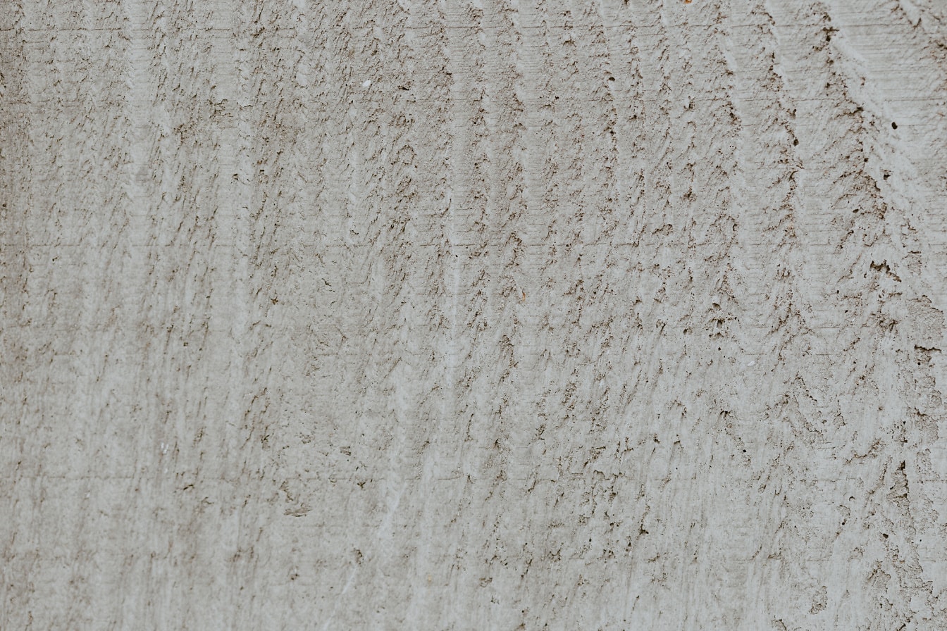 Tekstur dinding krem kotor dengan bekas noda di atasnya