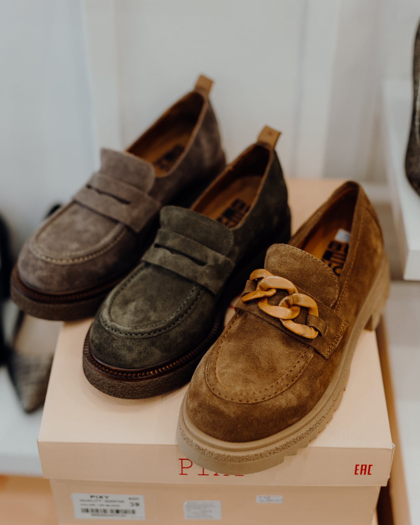Kézzel készített bőrcipők választéka kartondobozon a cipőboltban
