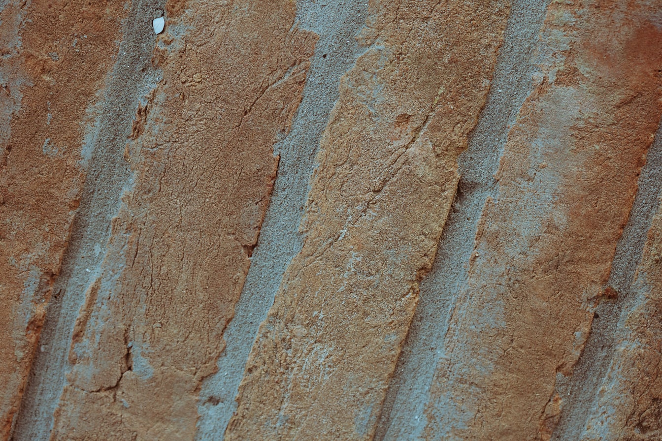 Close-up of a brick wall with reddish bricks stacked diagonally