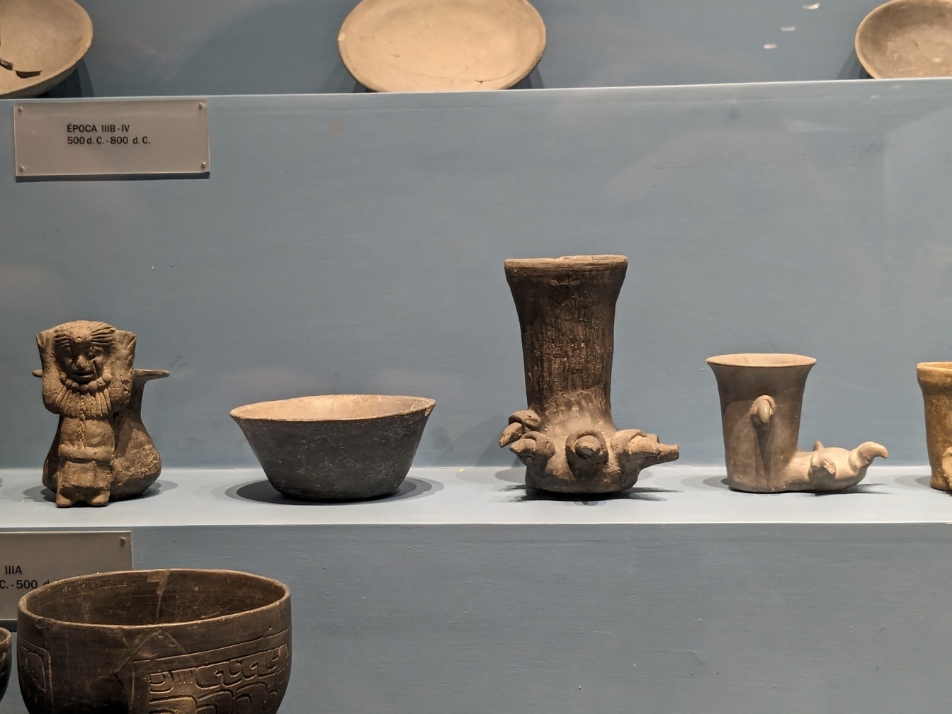 Ancient Mexican pottery on a shelf in archeological museum in Oxaca
