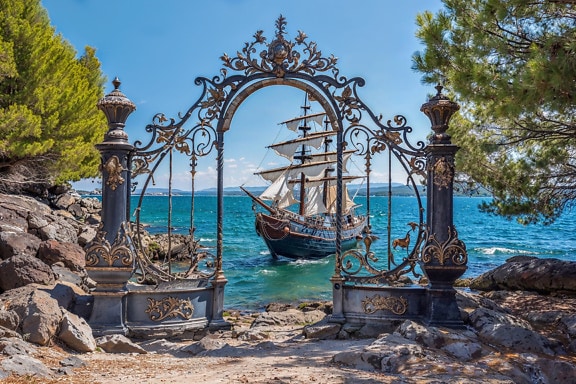 Cast iron gate in colonial style with a ship in the sea in Croatia