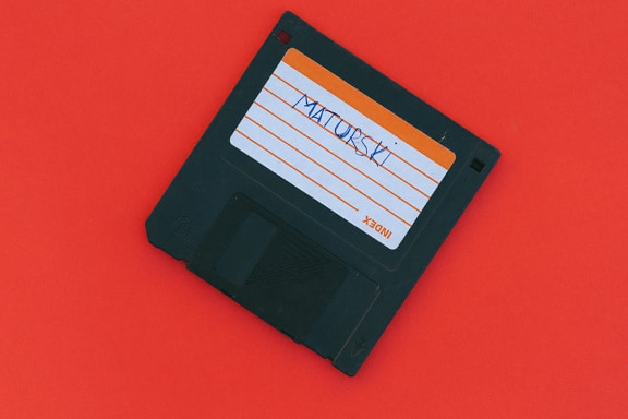 Black floppy disk with a label on it