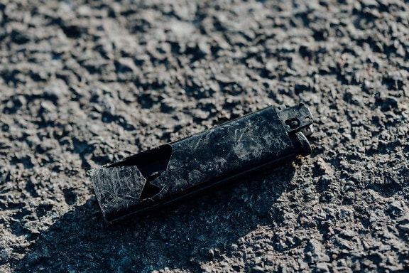 Old broken lighter on the ground