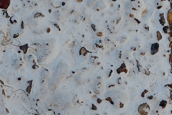 Tekstur av en hvit maling på en overflate av grov betong