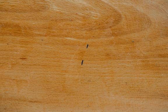 Texture of a light brown wood surface with stains