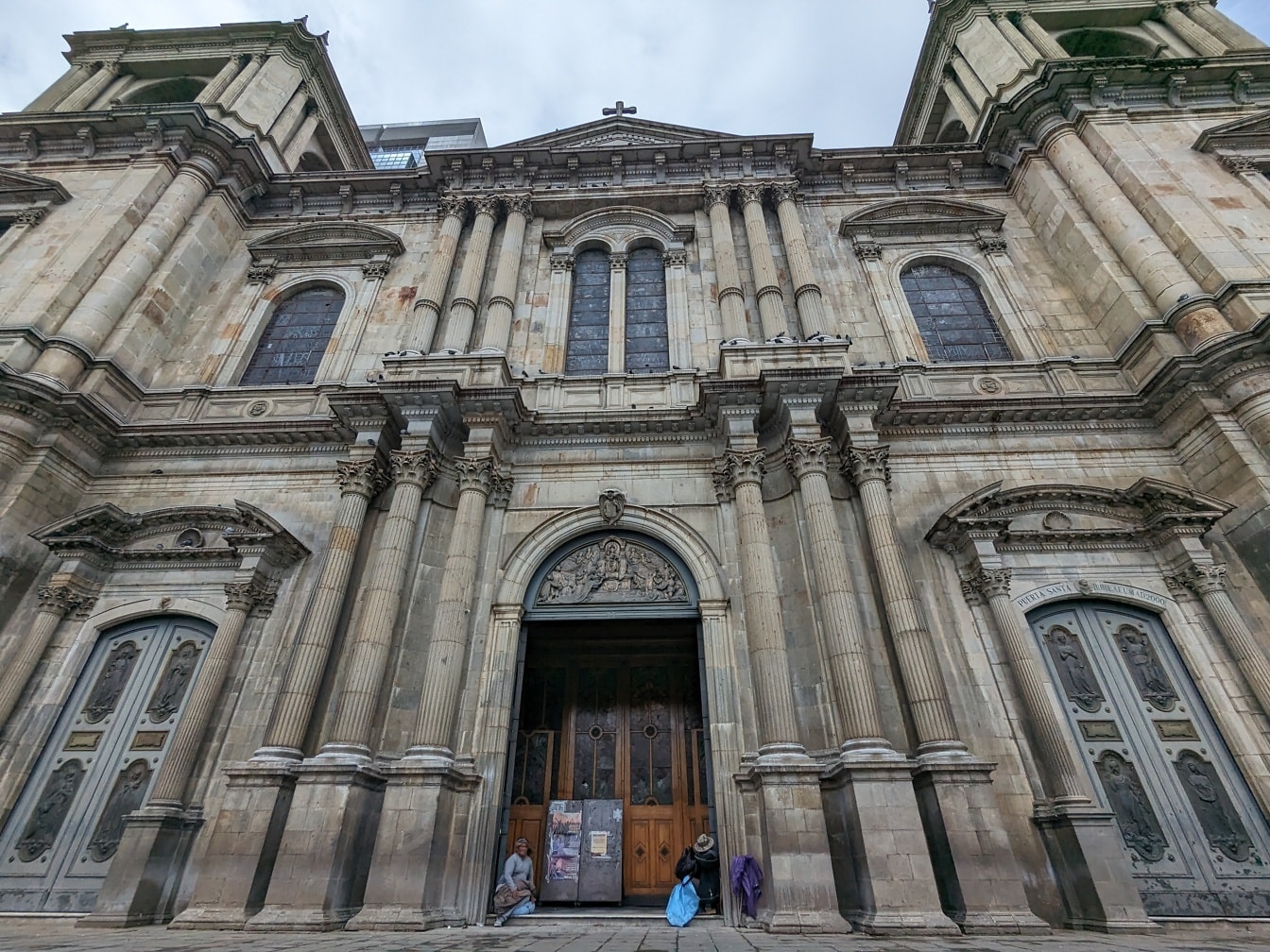 Cathedral on plaza Murillo in the city of La Paz with beggars standing at the front door