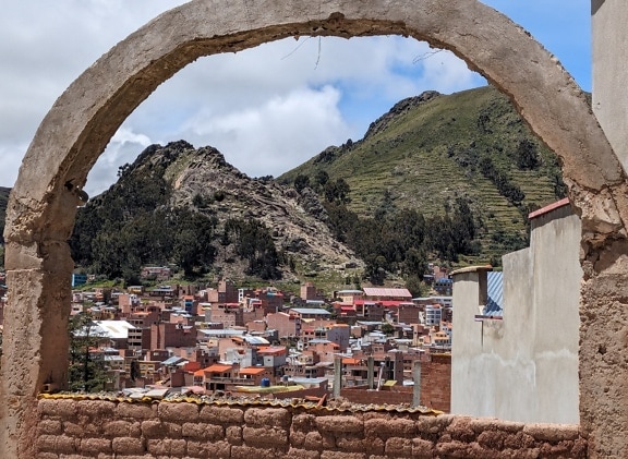 Panoramic view of Copacabana in Bolivia through stone arch