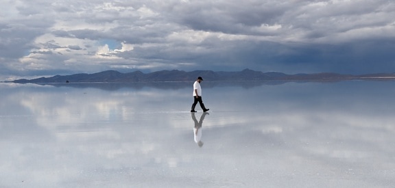 Illusion of man who walks on the surface of the lake
