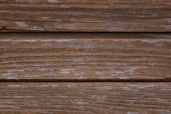 Texture of a lumber panel made of horizontal planks painted with faded brown paint