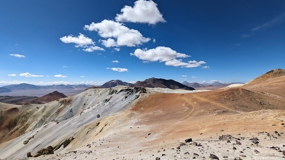 Landscape of driest desert in the world at high altitude with mountains and blue sky