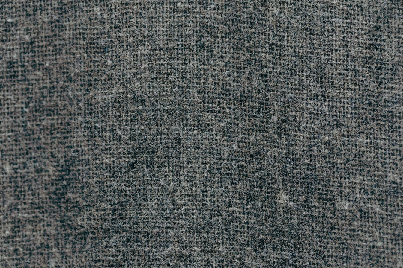 Textura šedivého plátna tkaného na základní matrici svislými a vodorovnými nitěmi